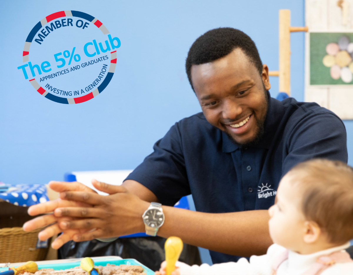 The 5% Club logo placed on a photo of an apprentice sitting with a child at the sand table